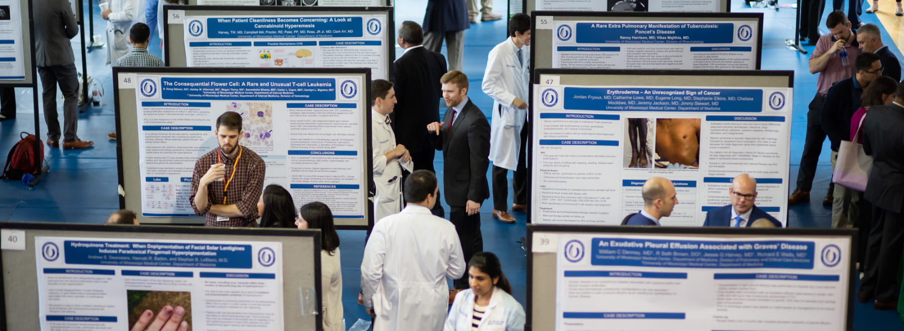 Research day crowd views project boards.